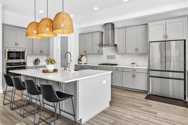 a kitchen with stainless steel appliances granite countertop a sink and cabinets