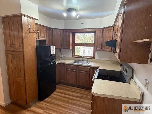 a kitchen with a refrigerator sink and stove