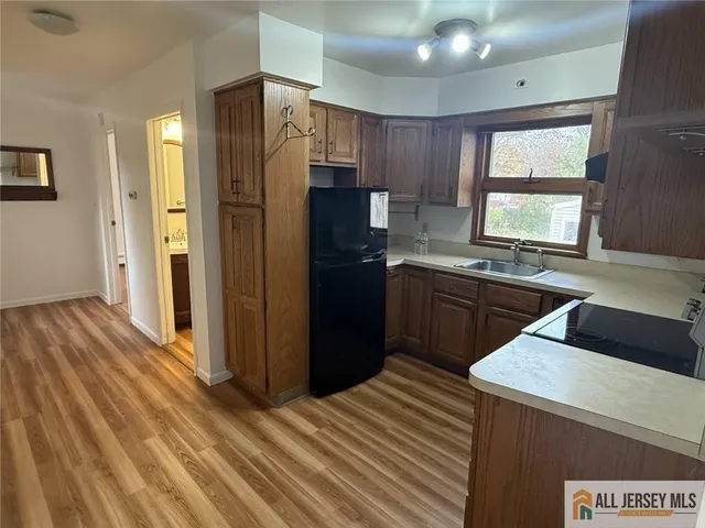 a kitchen with a sink a refrigerator and window