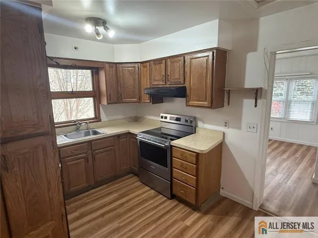 a kitchen with a stove and a sink