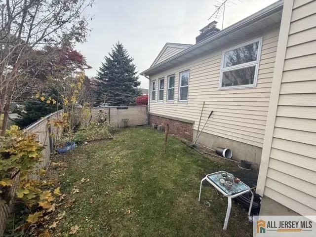 a view of a chair and table in the backyard