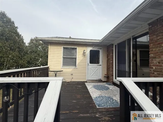 a view of a house with wooden deck