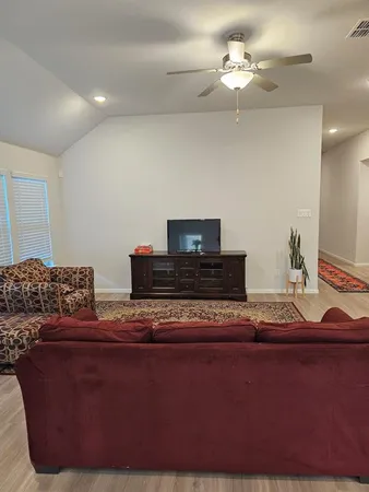 a living room with furniture and a lamp