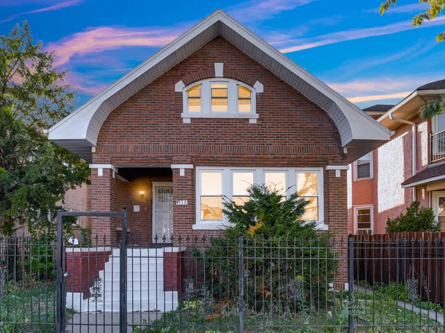 a front view of a house with plants