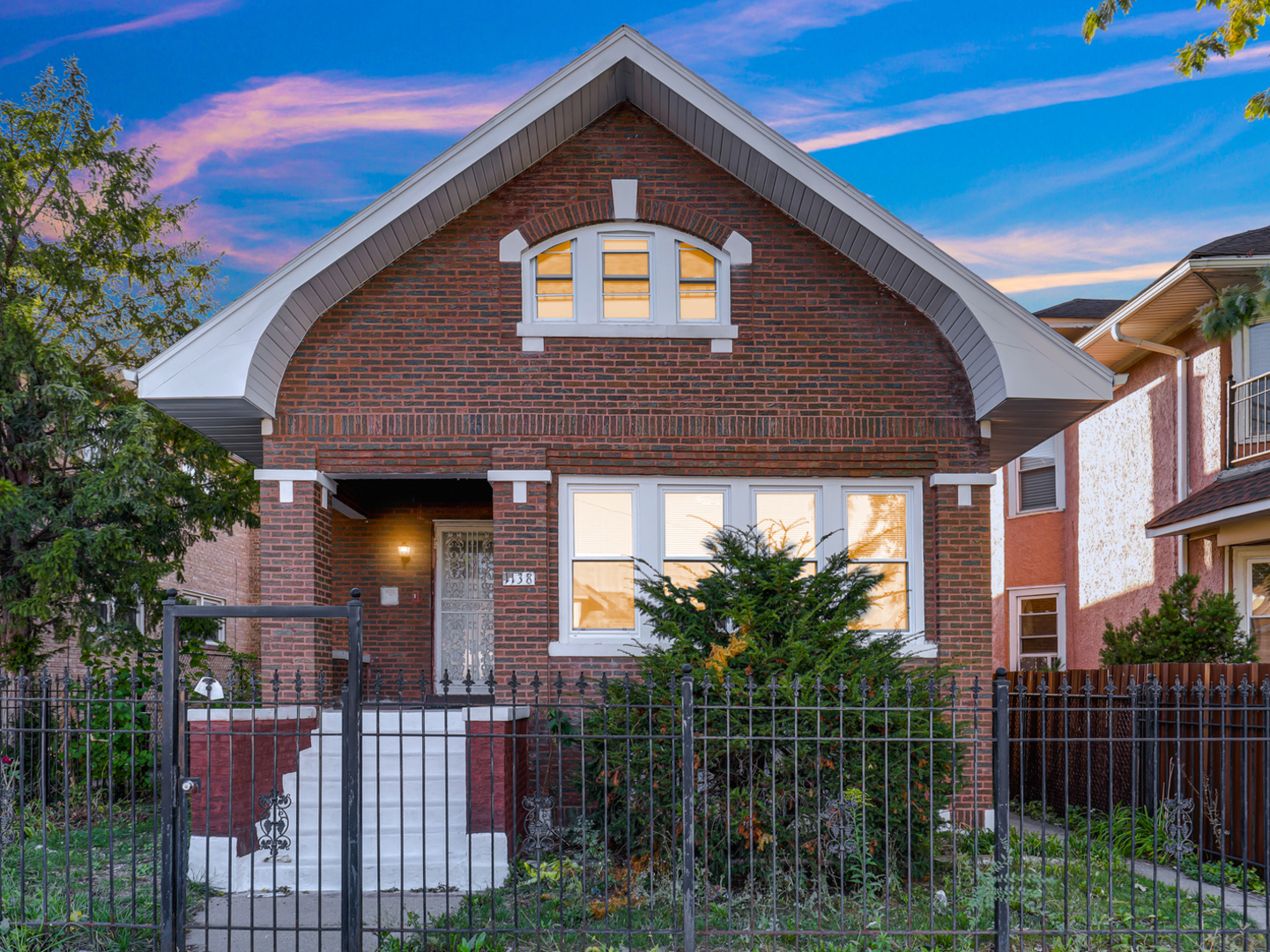 a front view of a house with plants