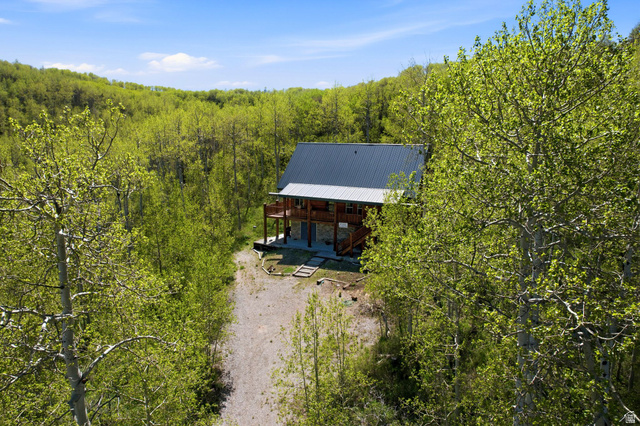 2096 South Aspen Ridge Coalville, UT 84017 - Photo 44 of 44 Log cabin exterior with an expansive surrounding landscape of mature trees