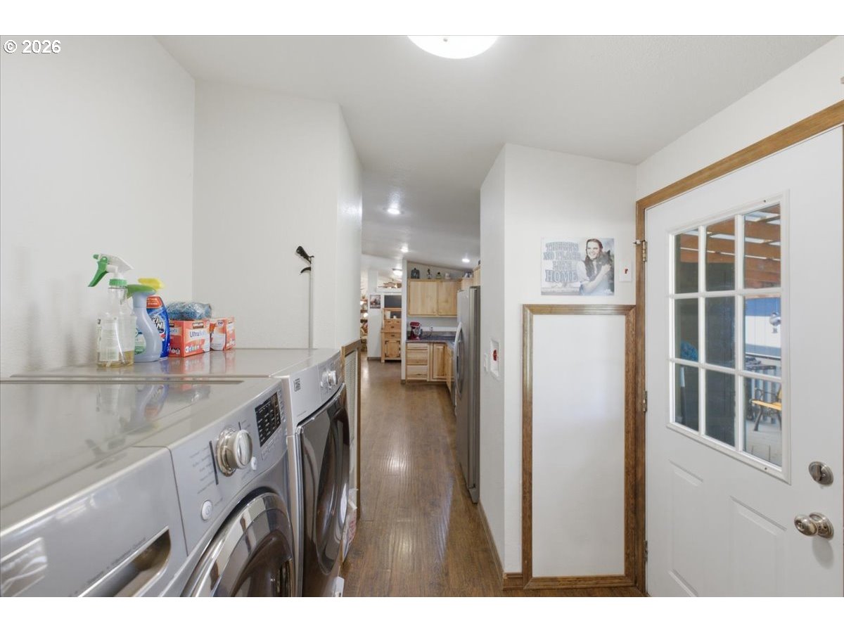 35377 Ede Road Lebanon, OR 97355 - Photo 16 of 48 a kitchen with kitchen island a counter top space a sink a refrigerator and a view of living room