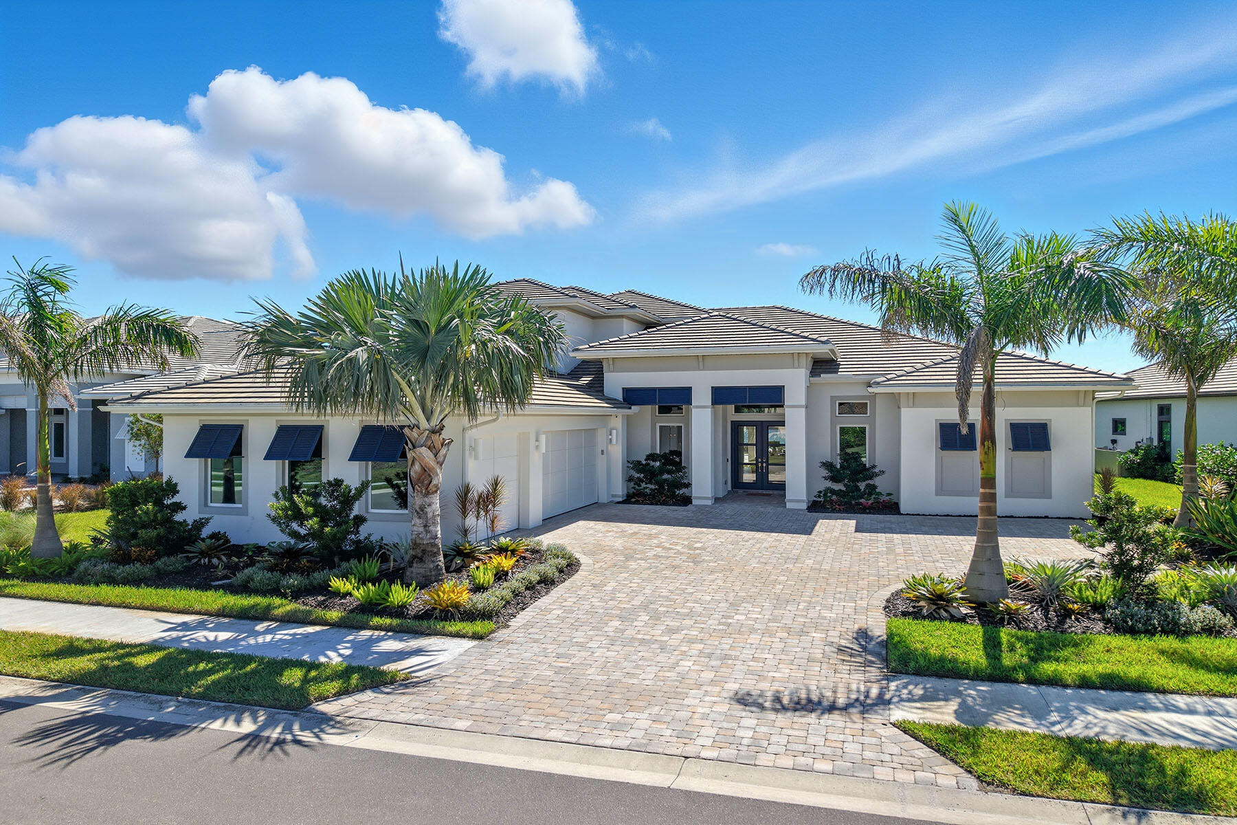 15326 Turin Drive Naples, FL 34114 - Photo 1 of 50 a front view of a house with a yard and potted plants