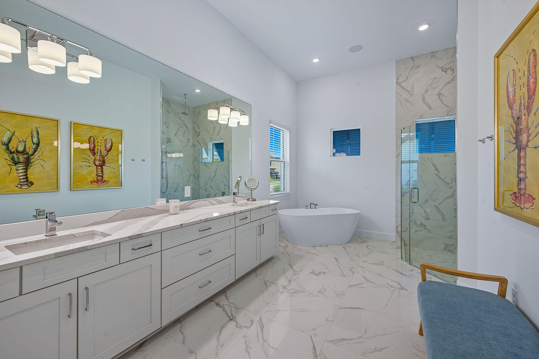15326 Turin Drive Naples, FL 34114 - Photo 14 of 50 a spacious bathroom with a double vanity sink a large mirror and a bathtub
