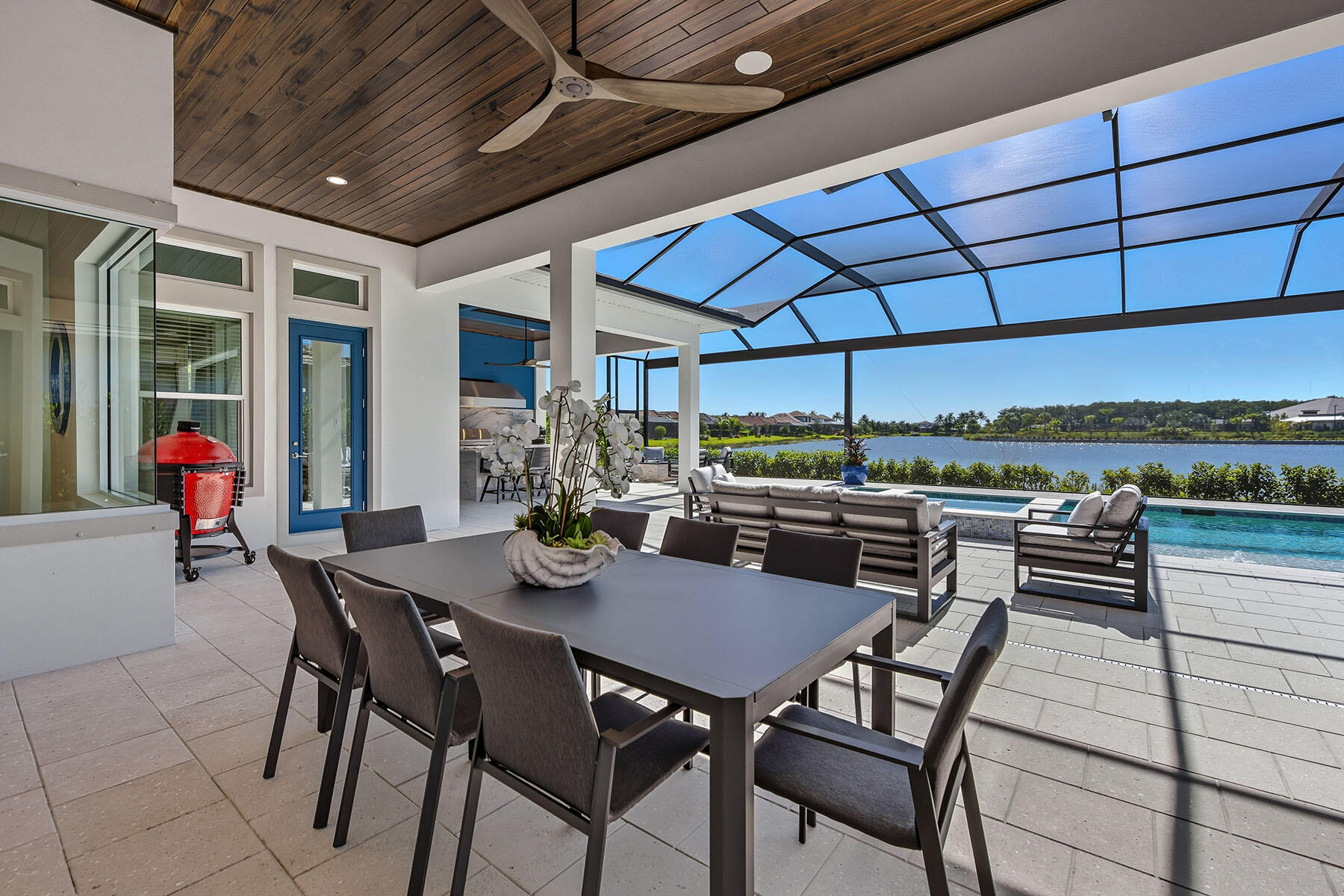 15326 Turin Drive Naples, FL 34114 - Photo 34 of 50 a view of a patio with a table and chairs under an umbrella