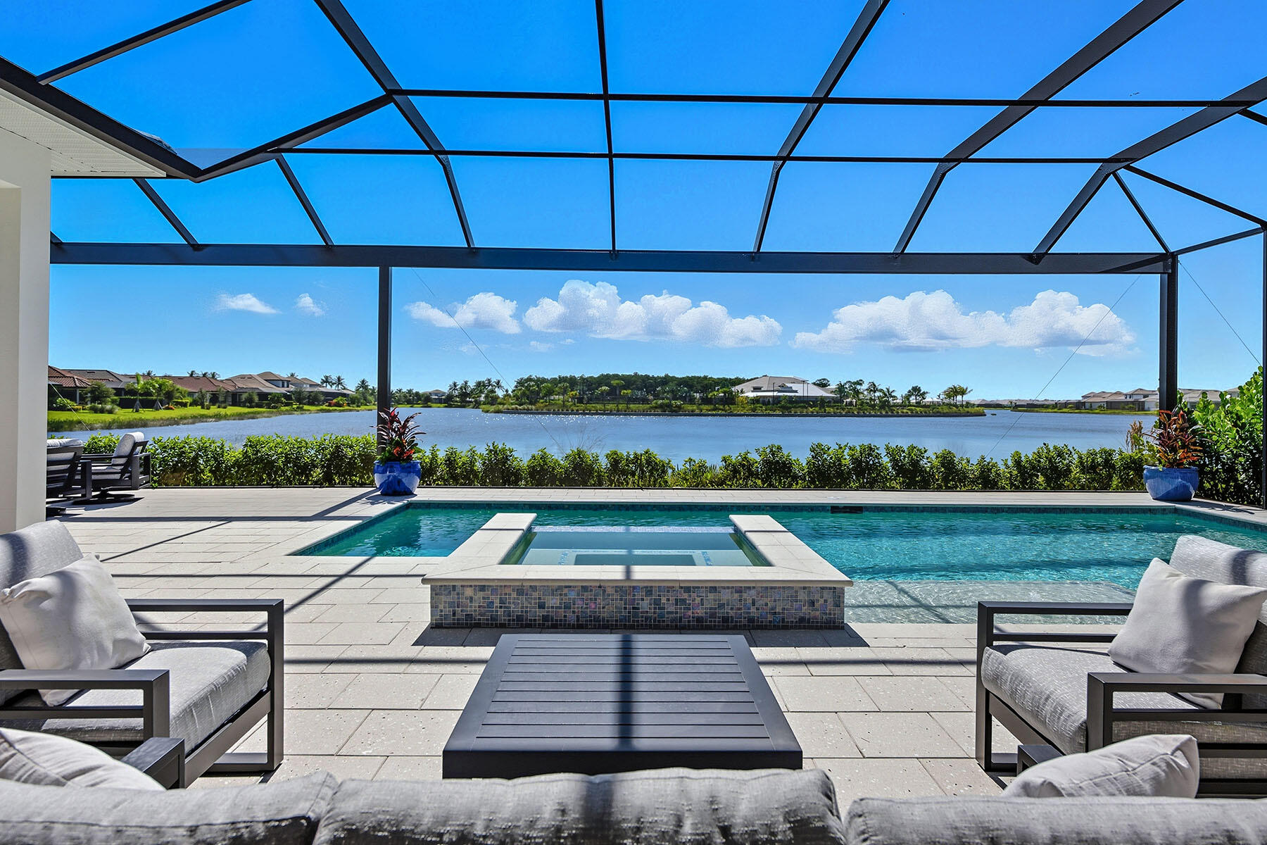 15326 Turin Drive Naples, FL 34114 - Photo 35 of 50 a view of swimming pool and lounge chairs in back yard