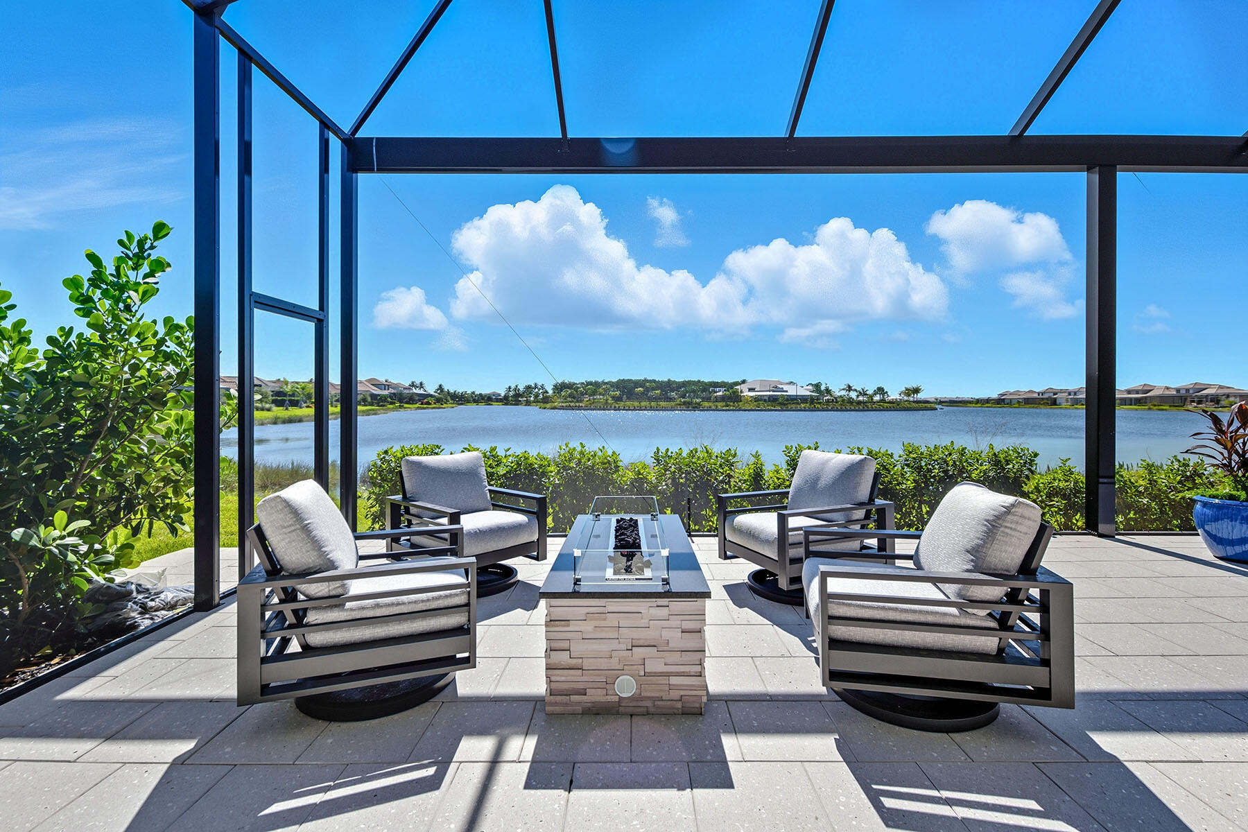 15326 Turin Drive Naples, FL 34114 - Photo 37 of 50 a roof deck with a table and chairs under an umbrella