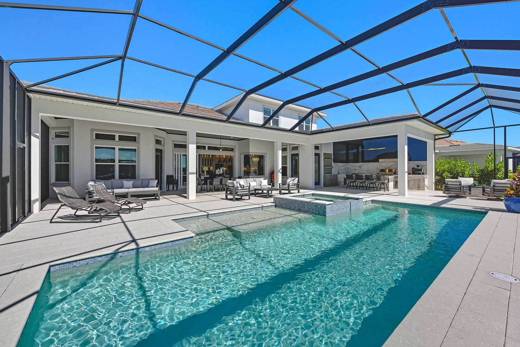 15326 Turin Drive Naples, FL 34114 - Photo 38 of 50 a view of a patio with table and chairs under an umbrella