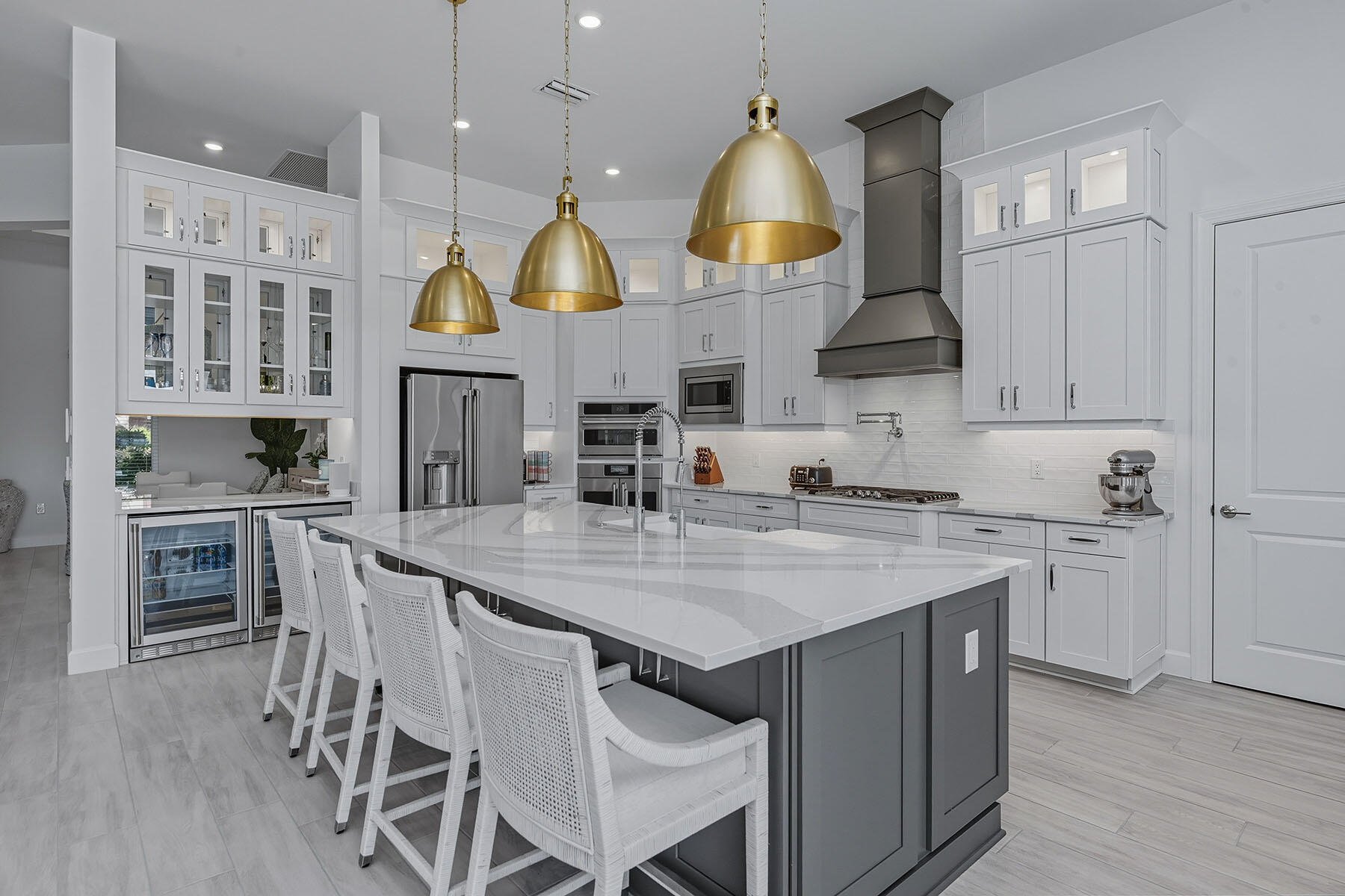 15326 Turin Drive Naples, FL 34114 - Photo 7 of 50 a kitchen with cabinets wooden floor and stainless steel appliances