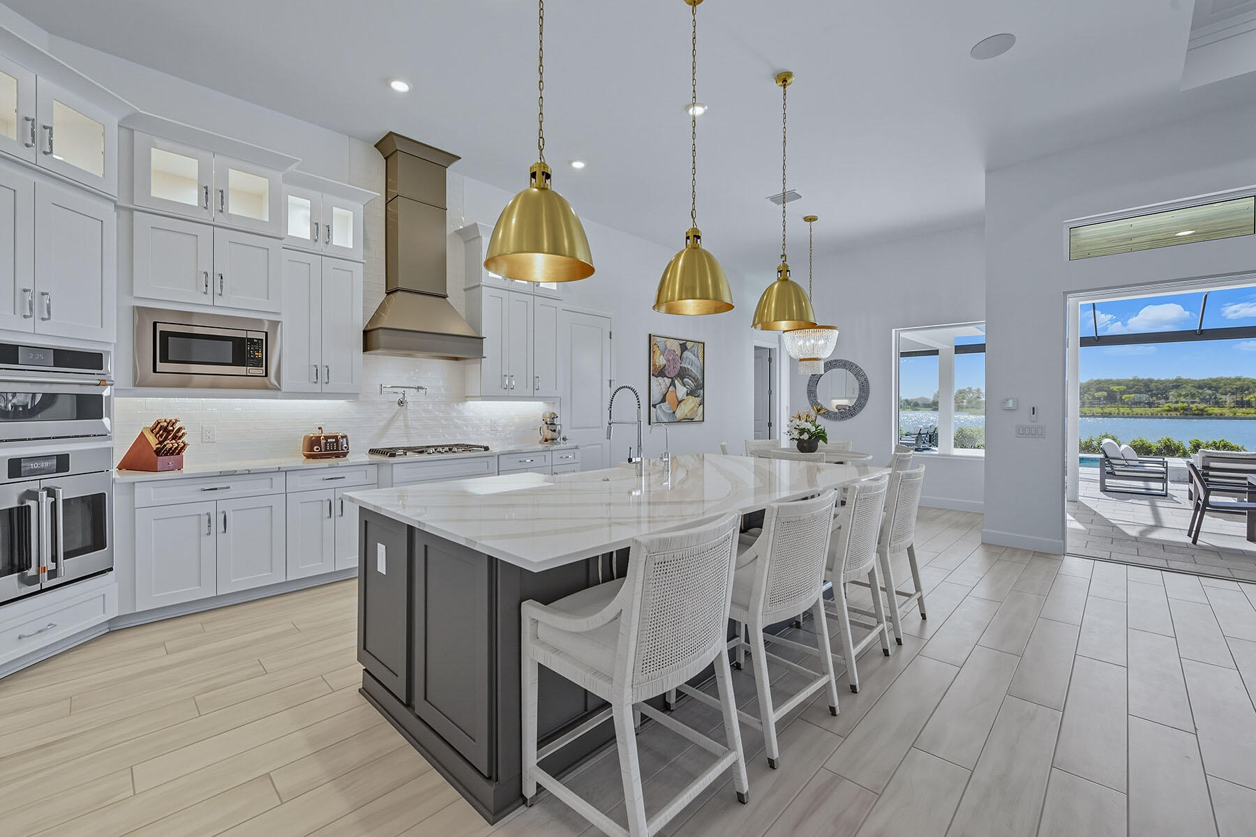 15326 Turin Drive Naples, FL 34114 - Photo 9 of 50 a kitchen with stainless steel appliances granite countertop a sink a stove top oven a counter space and cabinets