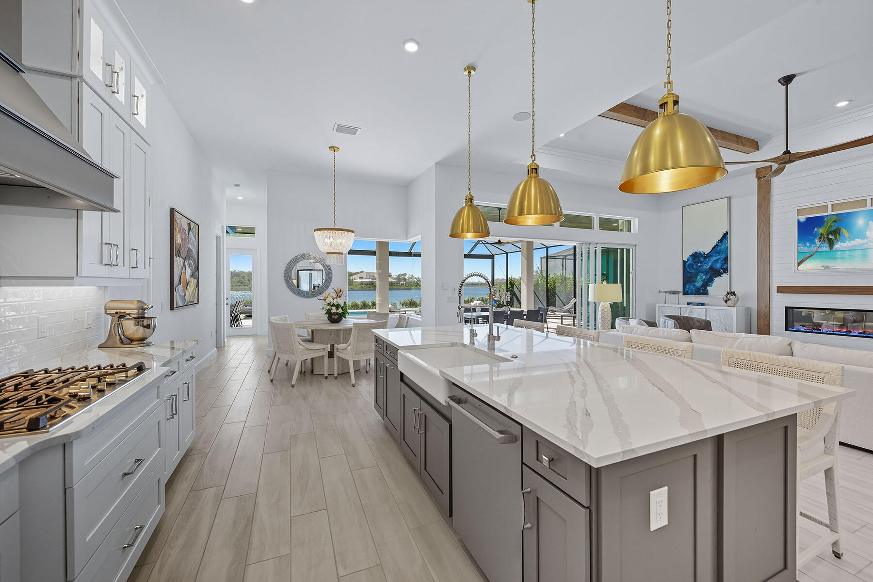 15326 Turin Drive Naples, FL 34114 - Photo 10 of 50 a kitchen with stainless steel appliances kitchen island granite countertop a stove a sink a refrigerator and a wooden floors