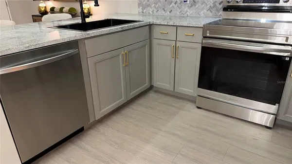 a kitchen with granite countertop cabinets stainless steel appliances and a granite counter tops