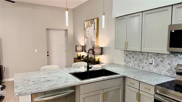 a kitchen with a sink stove and cabinets