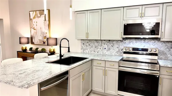 a kitchen with a sink stove and microwave