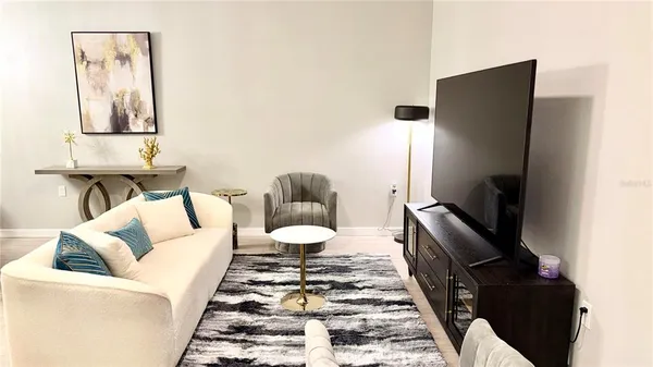 a living room with furniture and a rug