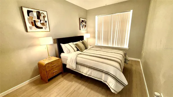 a bedroom with a bed and a window