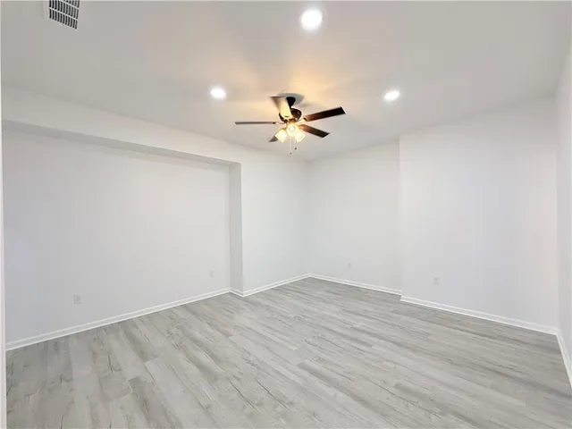 a view of an empty room with a ceiling fan