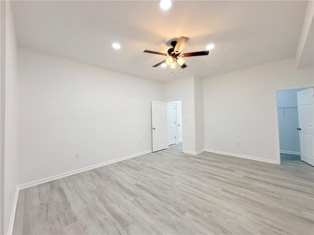 44 Dew Lk Court Grayson, GA 30017 - Photo 12 of 16 a view of empty room with wooden floor and ceiling fan
