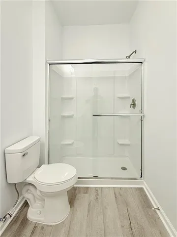 a white toilet sitting next to a bathroom sink