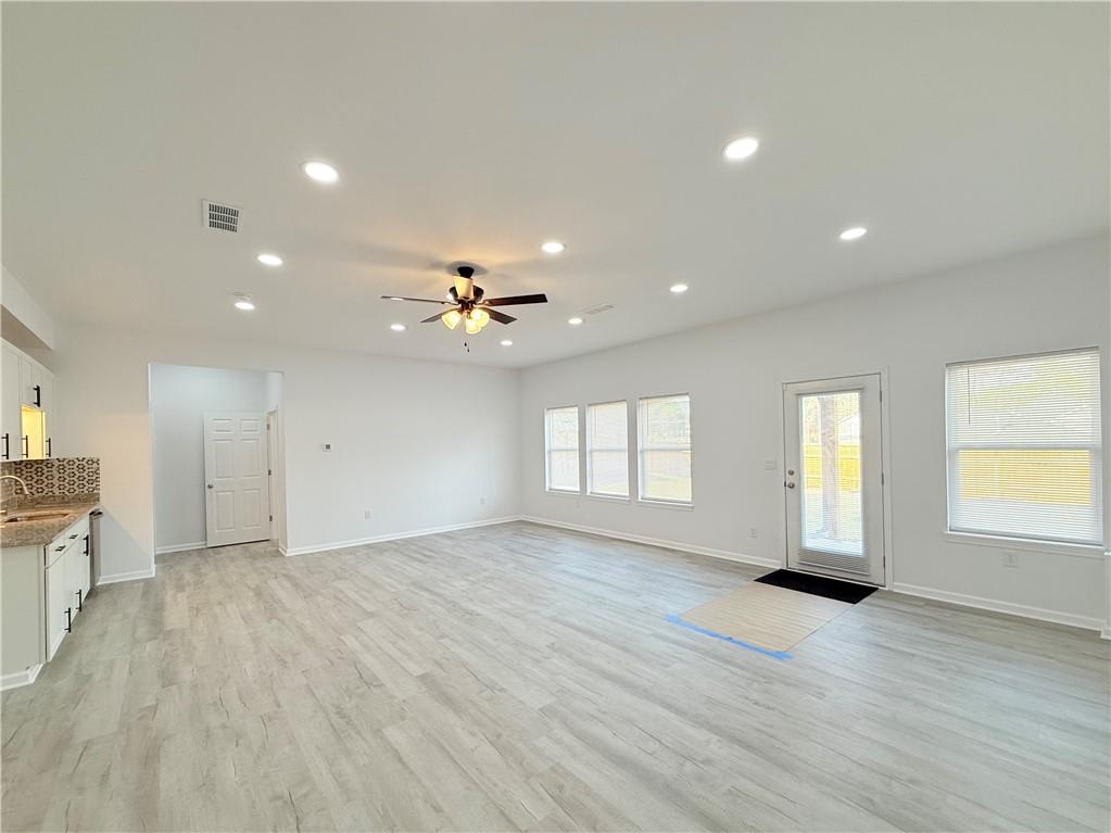44 Dew Lk Court Grayson, GA 30017 - Photo 4 of 16 an empty room with wooden floor and windows