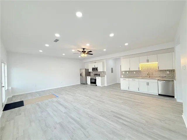 a view of a kitchen with a sink and a stove top oven