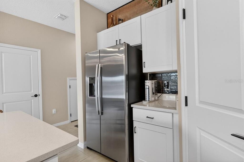 350 River Front Way Edgewater, FL 32141 - Photo 12 of 46 a kitchen with stainless steel appliances a refrigerator and a stove
