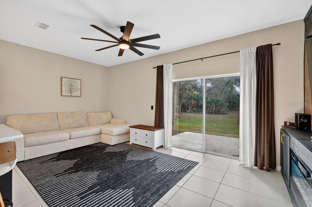 350 River Front Way Edgewater, FL 32141 - Photo 14 of 46 a living room with furniture and a floor to ceiling window