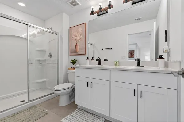 a bedroom with furniture and a lamp