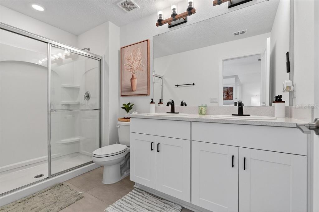 350 River Front Way Edgewater, FL 32141 - Photo 23 of 46 a bathroom with a shower sink vanity and toilet