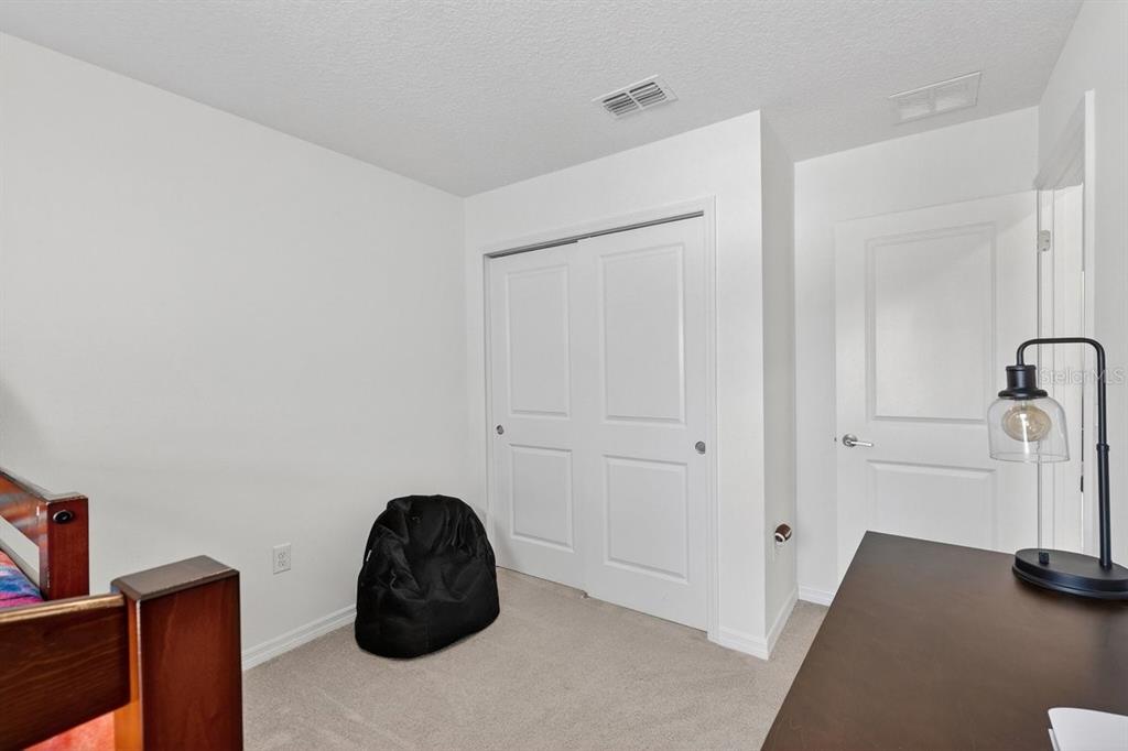 350 River Front Way Edgewater, FL 32141 - Photo 24 of 46 a bedroom with a bed and a dresser