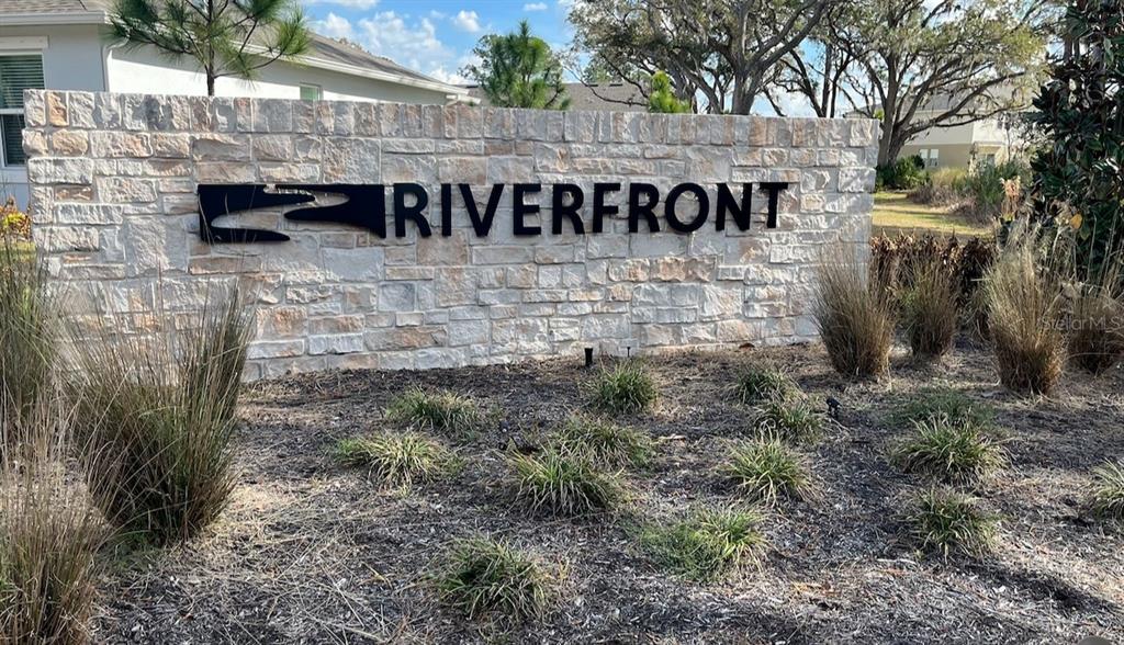 350 River Front Way Edgewater, FL 32141 - Photo 4 of 46 a view of a street sign under a large tree