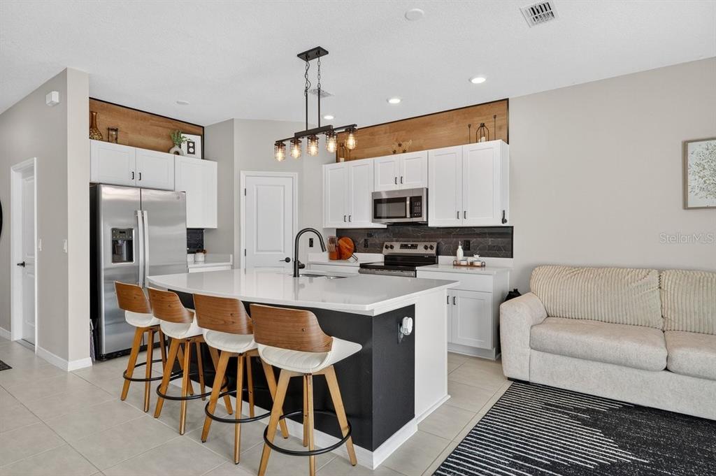 350 River Front Way Edgewater, FL 32141 - Photo 7 of 46 a kitchen with appliances a sink and cabinets