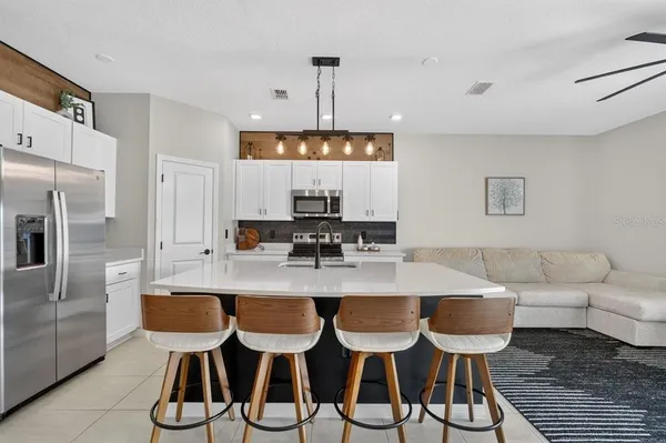 a living room with furniture and kitchen view