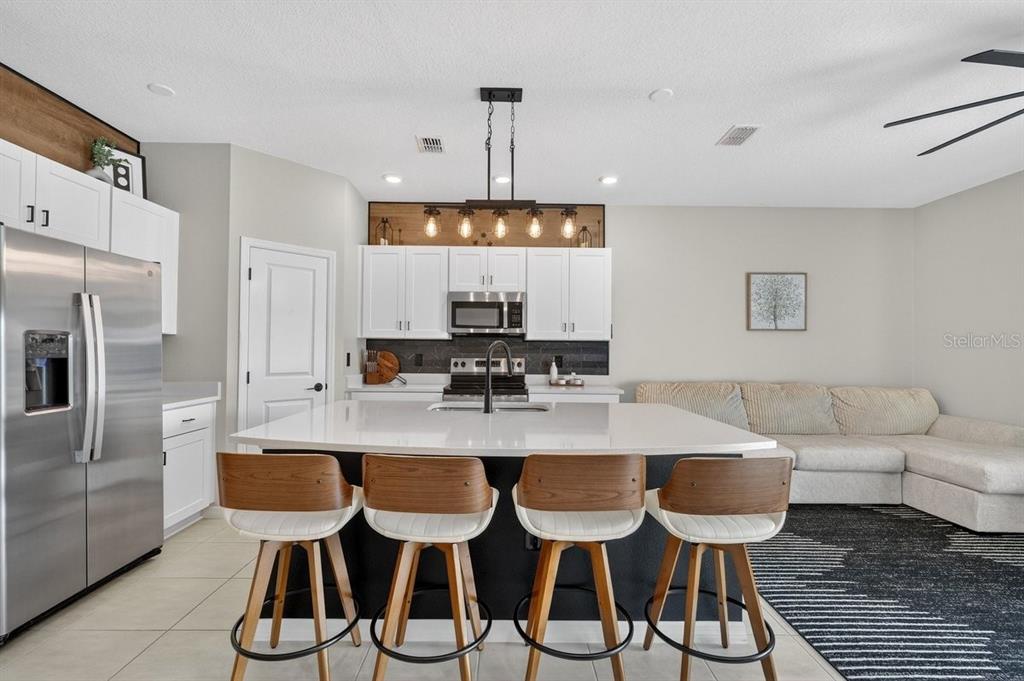 350 River Front Way Edgewater, FL 32141 - Photo 8 of 46 a kitchen with granite countertop lots of counter top space dining table and stainless steel appliances