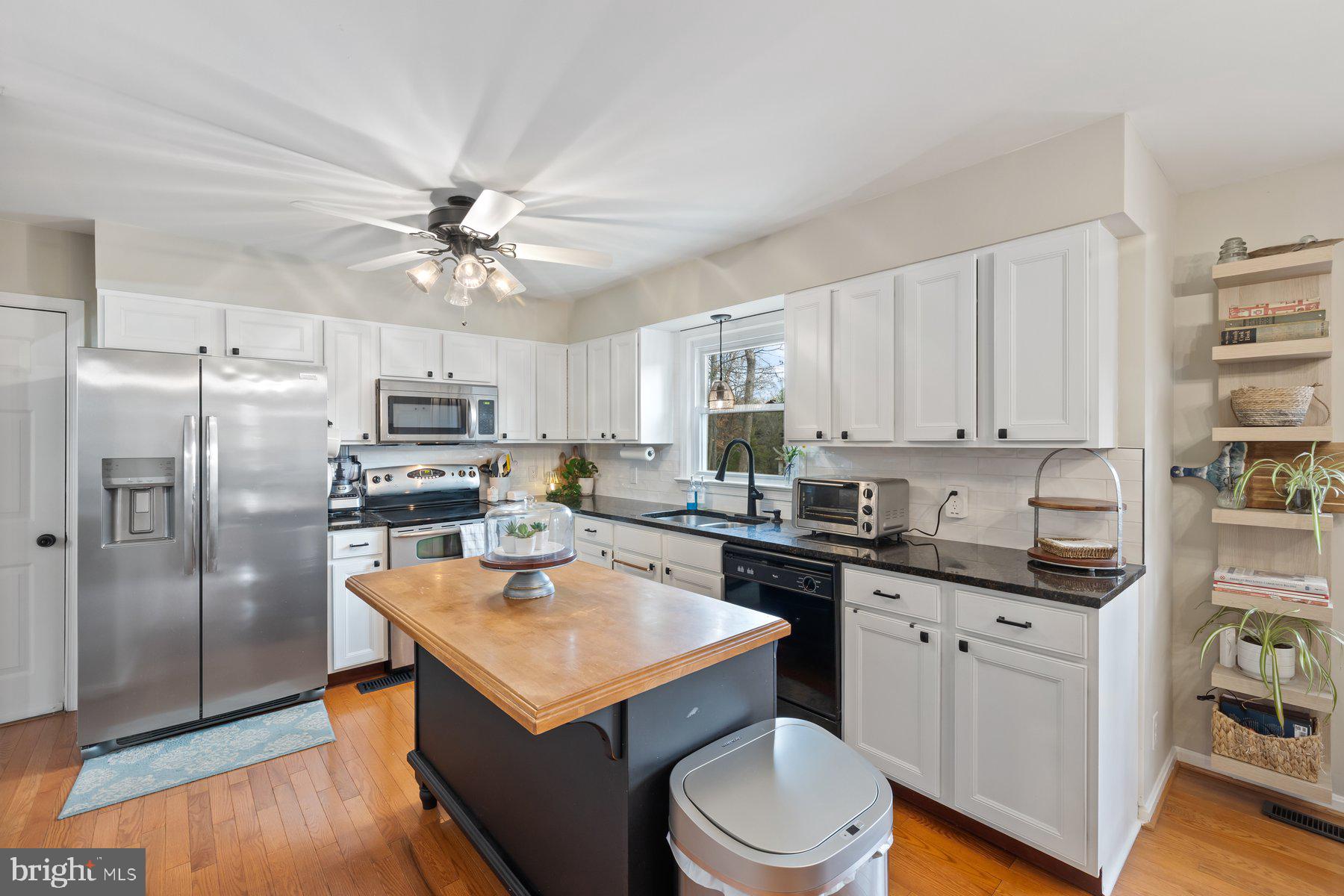 15 Tarleton Way Stafford, VA 22554 - Photo 35 of 74 a kitchen with a sink a stove a refrigerator and white cabinets