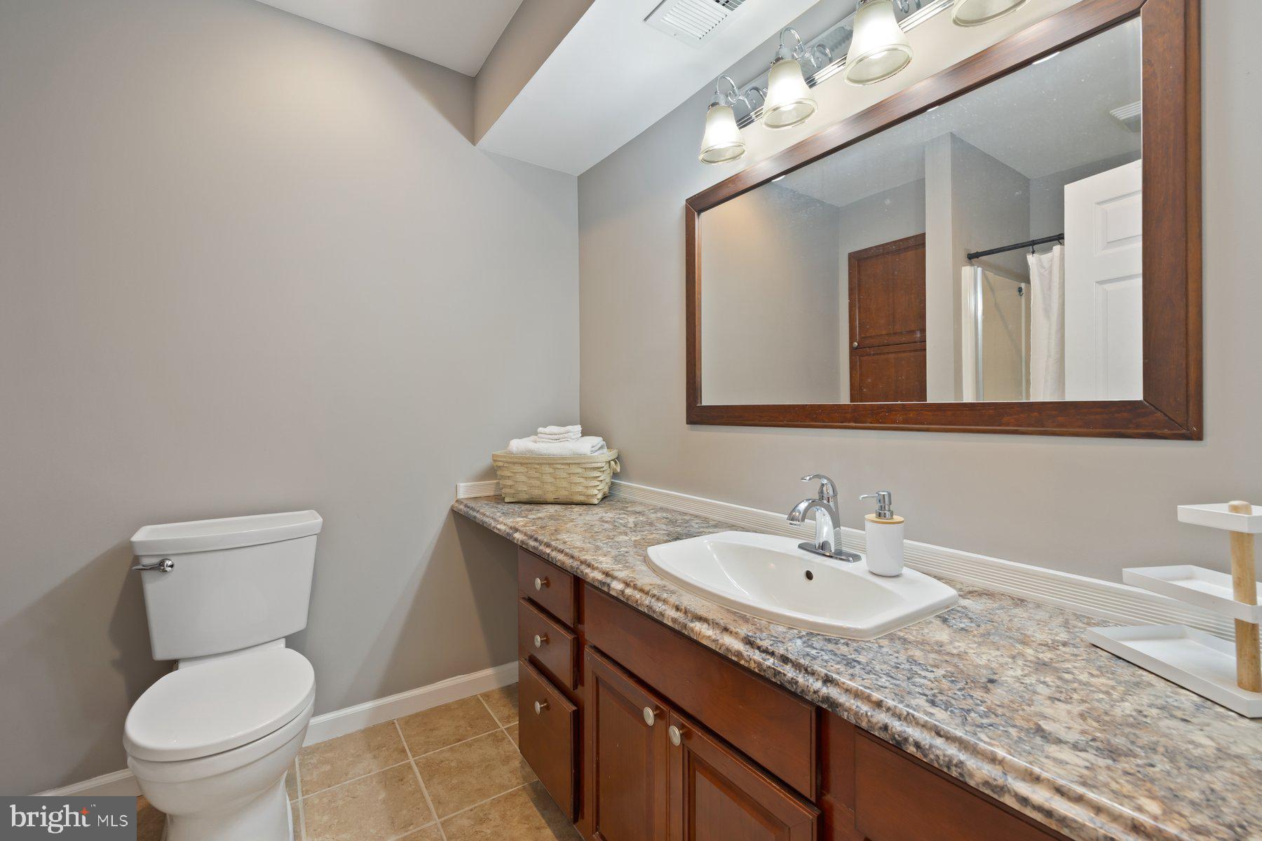 15 Tarleton Way Stafford, VA 22554 - Photo 66 of 74 a bathroom with a granite countertop toilet sink and mirror