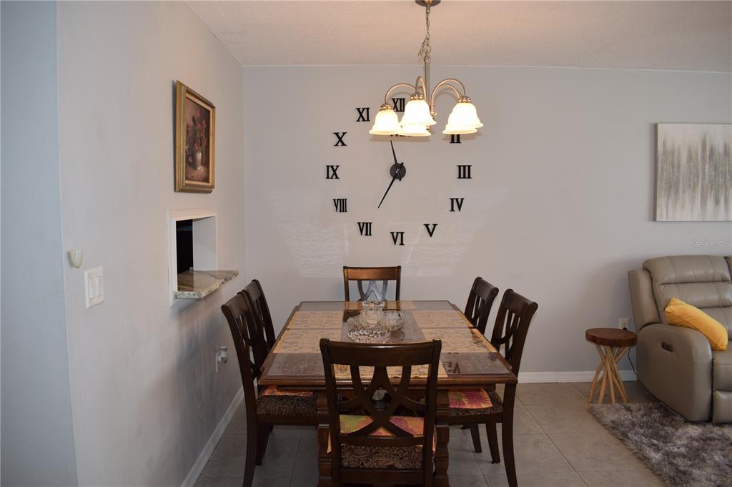 245 Center Road, Unit 104 Venice, FL 34285 - Photo 11 of 37 a view of a dining room with furniture wooden floor and a chandelier
