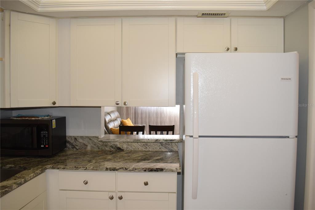 245 Center Road, Unit 104 Venice, FL 34285 - Photo 20 of 37 a kitchen with a refrigerator and a stove