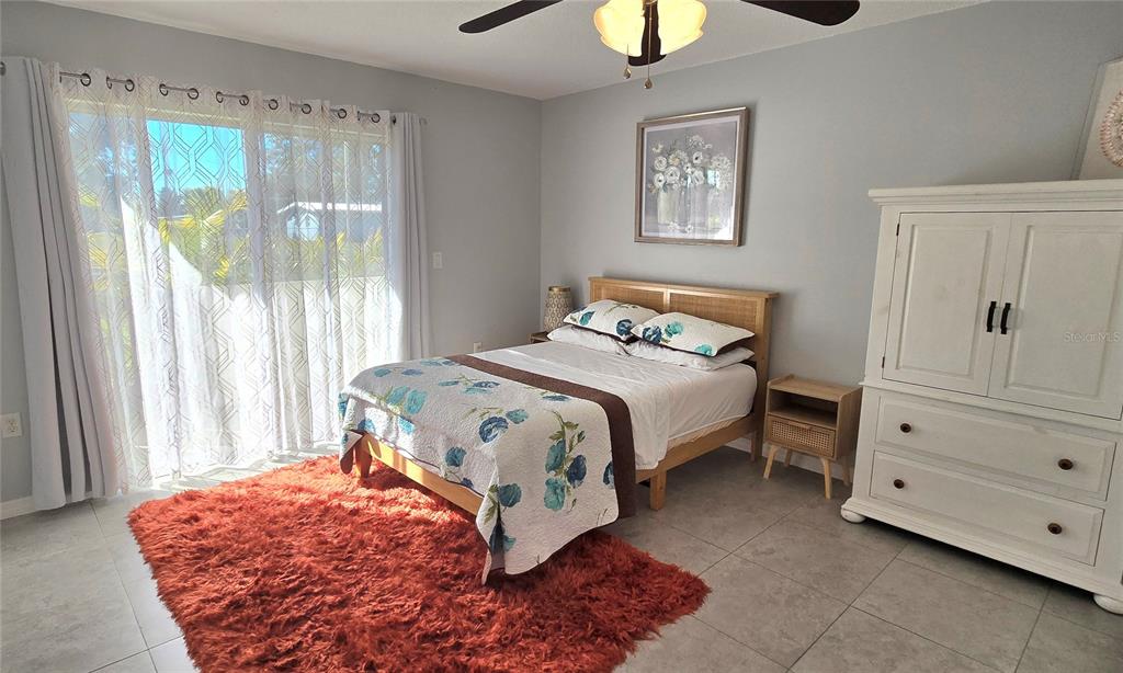 245 Center Road, Unit 104 Venice, FL 34285 - Photo 21 of 37 a bedroom with a bed and a window