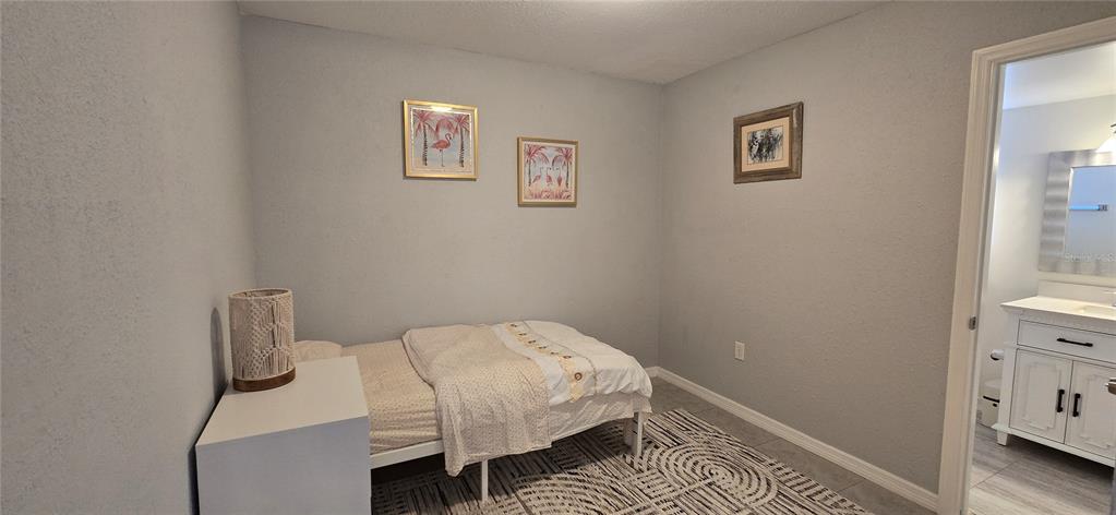 245 Center Road, Unit 104 Venice, FL 34285 - Photo 26 of 37 a bedroom with a bed and a window