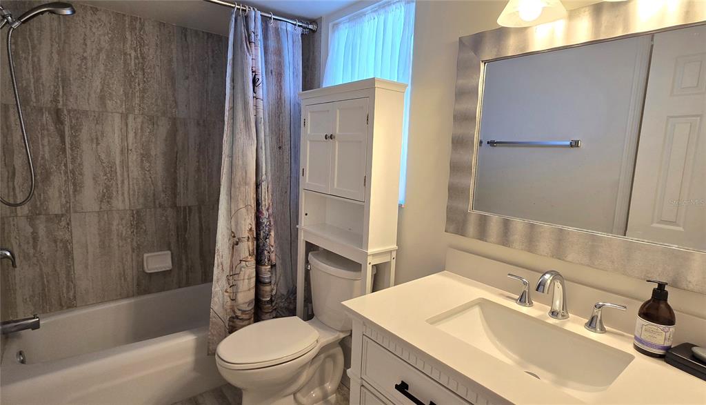 245 Center Road, Unit 104 Venice, FL 34285 - Photo 30 of 37 a bathroom with a sink toilet and shower