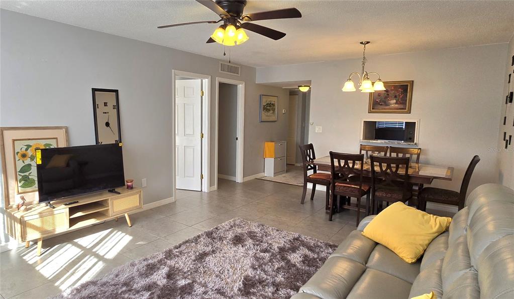 245 Center Road, Unit 104 Venice, FL 34285 - Photo 6 of 37 a view of a livingroom with furniture and a flat screen tv