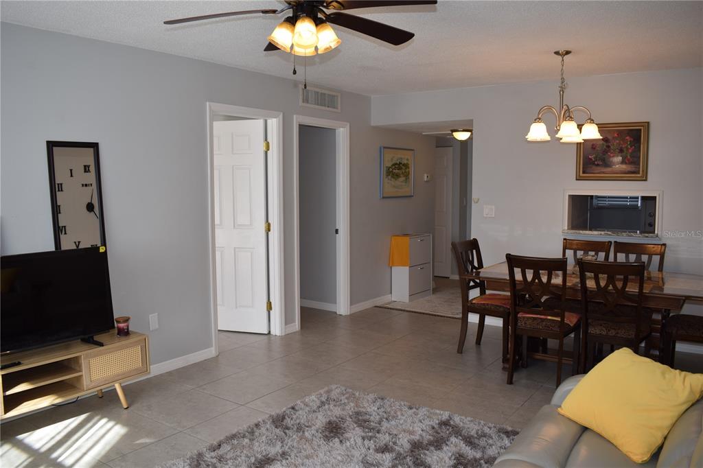 245 Center Road, Unit 104 Venice, FL 34285 - Photo 8 of 37 a view of a livingroom with furniture and chandelier