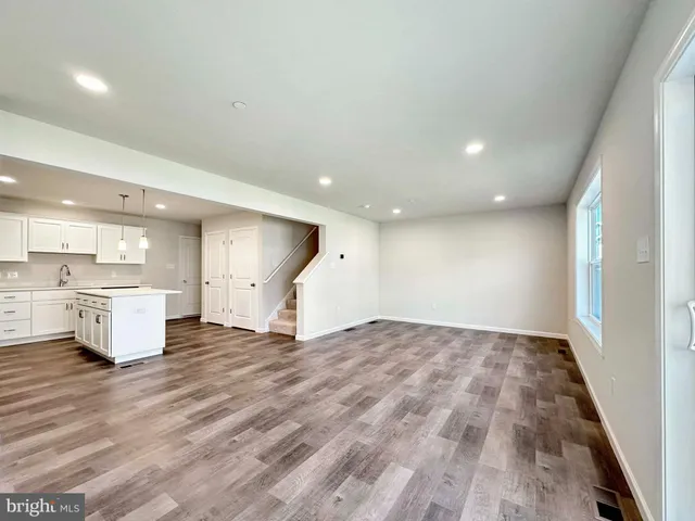 a view of a kitchen with a sink and a refrigerator