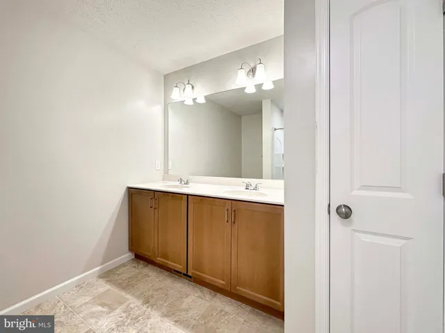 a bathroom with a sink a mirror and a shower